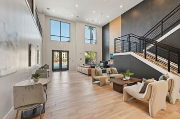 A spacious living room with a staircase on the right side.